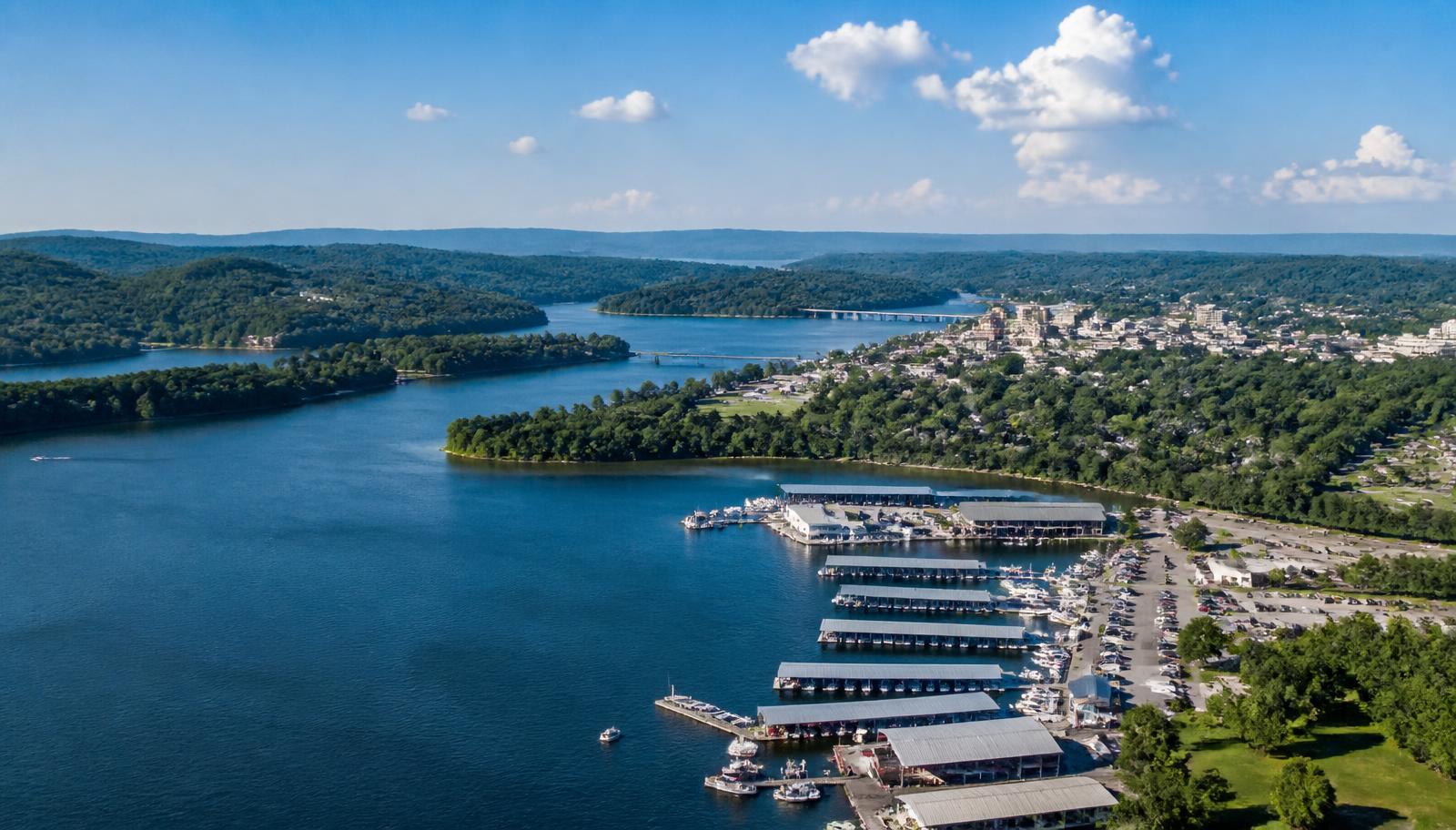 Aerial view of a lake shoreline and marina beside a small Tennessee city — illustrative Cherokee Lake scene near Morristown.