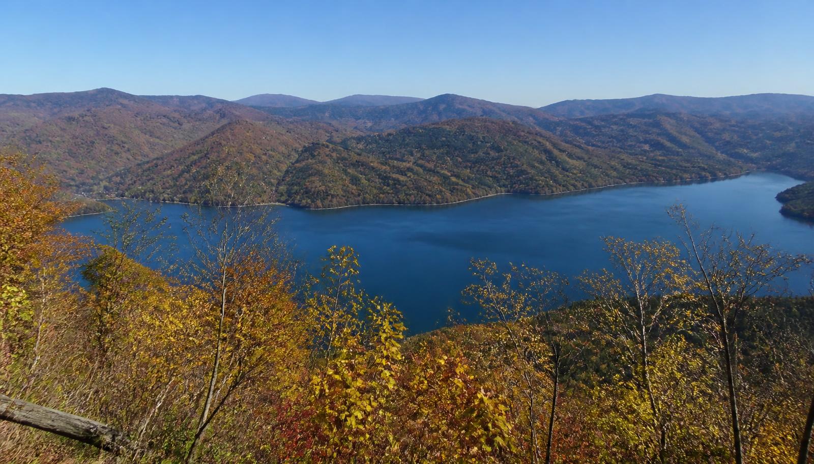 View from a wooded ridge over a wide blue lake in autumn — illustrative Cherokee Lake scene.